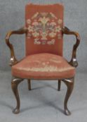 An early Georgian style walnut framed armchair in tapestry upholstery. H.90cm