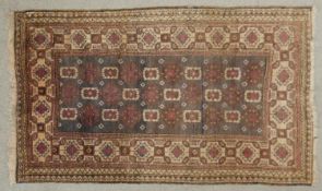 A Belouch rug with repeating medallions within hooked diamond multiple borders. L.150 W.86cm