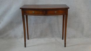 A Georgian style figured mahogany and crossbanded console table by Reprodux with two frieze