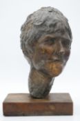 A sculpted bronze head of a female figure. Mounted on a wooden base. H.42cm
