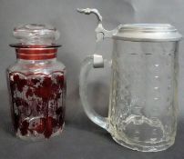 A Bohemian ruby flash glass lidded jar with vine design along with a cut crystal glass lidded