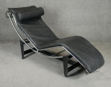 A mid century vintage leather reclining chaise after a design by Le Corbusier, model LC4, in black