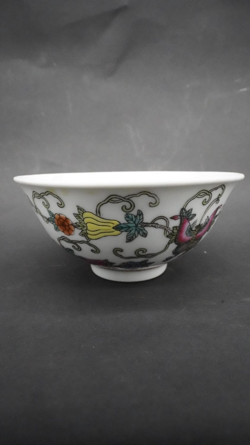 A pair of Chinese Qing period Famille Rose porcelain bowls. Decorated with flowers, fruit and - Image 2 of 3