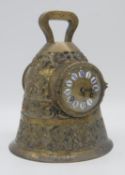 A 19th century French brass mantel clock modelled as a bell, the dial with enamel Roman numerals,