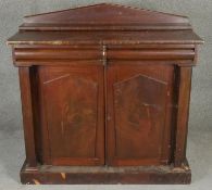 A mid 19th century flame mahogany chiffonier with raised back above frieze drawers and arched