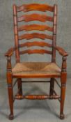 A 19th century style fruitwood ladder back armchair. H.106cm