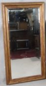 A gilt framed dressing mirror with bevelled plate. H.131 W.69cm