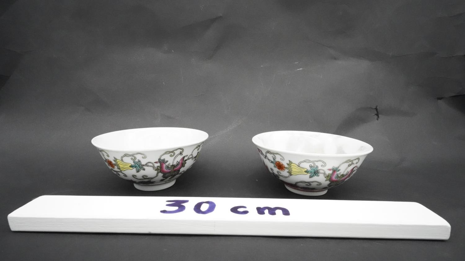 A pair of Chinese Qing period Famille Rose porcelain bowls. Decorated with flowers, fruit and