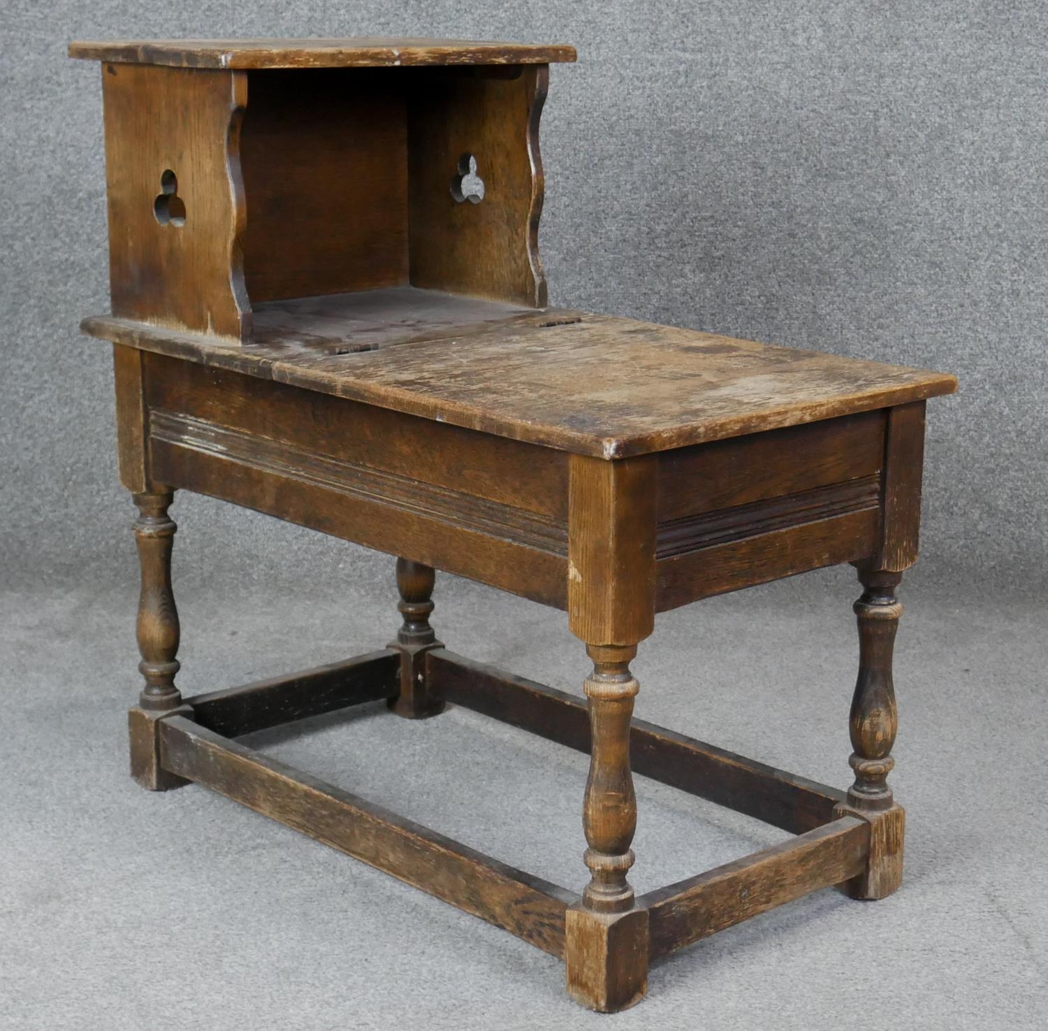 A Jacobean style oak hall table with hinged lidded compartment on turned stretchered supports. H.