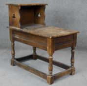 A Jacobean style oak hall table with hinged lidded compartment on turned stretchered supports. H.