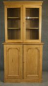 A 19th century pine dresser or bookcase with glazed upper section enclosing shelves above panel