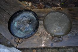A pair of vintage copper and brass twin handled pans