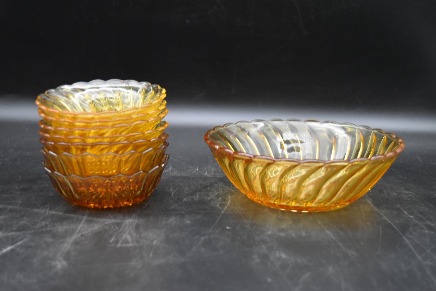 A set of seven vintage amber swirl depression glass fruit dessert bowls. H.7 Dia.20cm