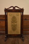 A 19th century flame mahogany French Empire style fire screen with inset palmette and wreath