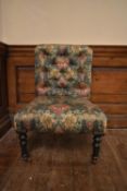A 19th century nursery chair in Liberty style buttoned upholstery on ebonised tapering supports. H.
