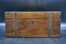 A mid 19th century walnut and brass bound writing slope, fitted interior with single glass inkwell