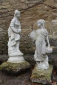 A pair of composite white painted garden statues of young female figures. One holding a bird and the