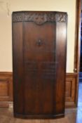 A mid century oak Jacobean style hall cupboard fitted with interior shelf and hanging space. H.183