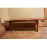 A Gordon Russell teak low table on tapering supports. H.40 W.121 D.45cm