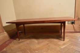 A Gordon Russell teak low table on tapering supports. H.40 W.121 D.45cm