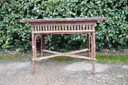 A vintage bamboo conservatory table with faux ceramic tiled top. H.68 W.96 D.66cm