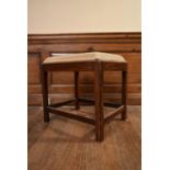 A 19th century mahogany piano stool with drop in tapestry seat on square stretchered supports. H.