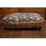 An upholstered stool on turned supports in William Morris style loose cover. H.39 W. 110 D.90cm