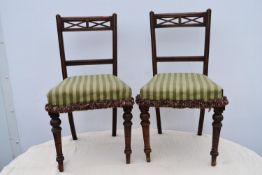 A pair of late 19th century oak dining chairs.