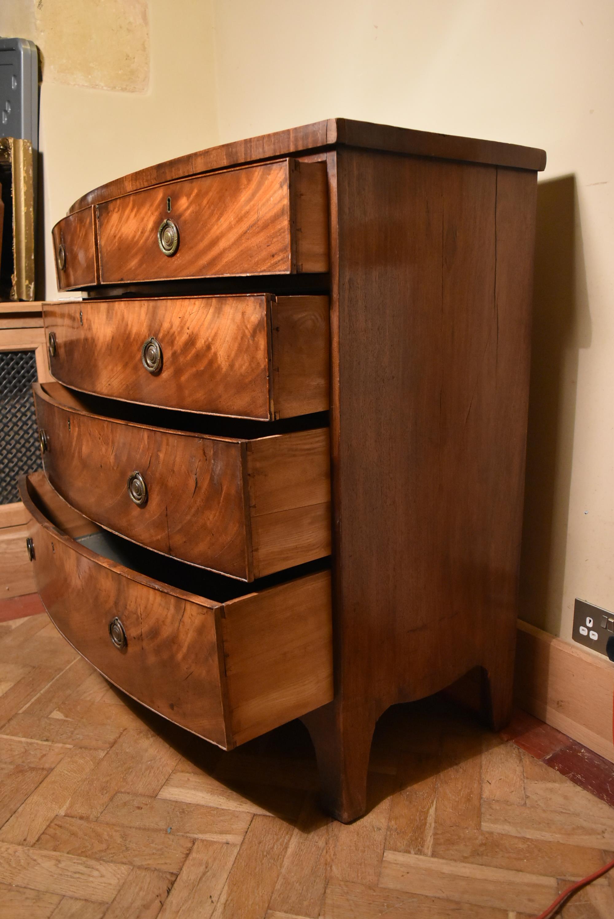 A Georgian flame mahogany bow fronted chest on swept bracket supports. - Image 4 of 7