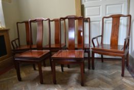 A set of six Chinese hardwood dining chairs with panel seats on shaped supports, to include two