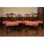 A set of six mahogany Hepplewhite style dining chairs with pierced vase shaped back splats above