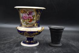 A 19th century campagna shape porcelain vase with hand painted floral decoration along with an