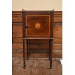 A Georgian mahogany and satinwood inlaid bedside cabinet with circular floral patera to the panel