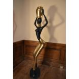 A mid century modern brass and copper African lady sculpture in the style of Karl Hagenauer. H.165