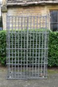 An Industrial style metal wire mesh wine rack fitted with pair of doors. H.163 W.100 D.50cm