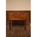 A 19th century mahogany drop flap Pembroke table fitted with frieze drawer on turned tapering