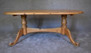 A large pine oval topped kitchen table. H.72 x 180 x 96cm