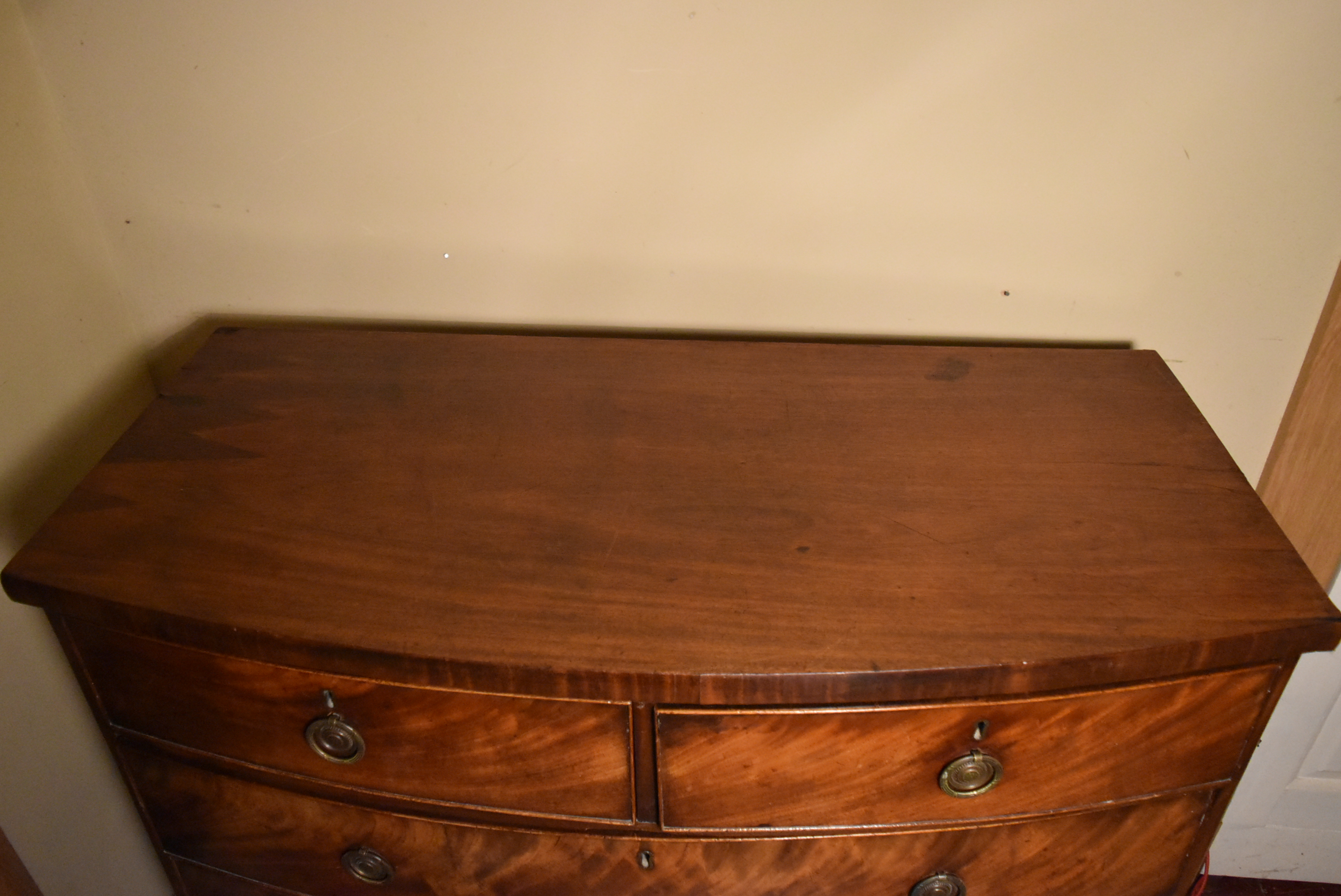 A Georgian flame mahogany bow fronted chest on swept bracket supports. - Image 3 of 7