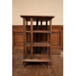 A C.1900 oak revolving bookcase by Goodall Lamb and Highway of Manchester, bears a central plaque