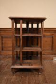 A C.1900 oak revolving bookcase by Goodall Lamb and Highway of Manchester, bears a central plaque
