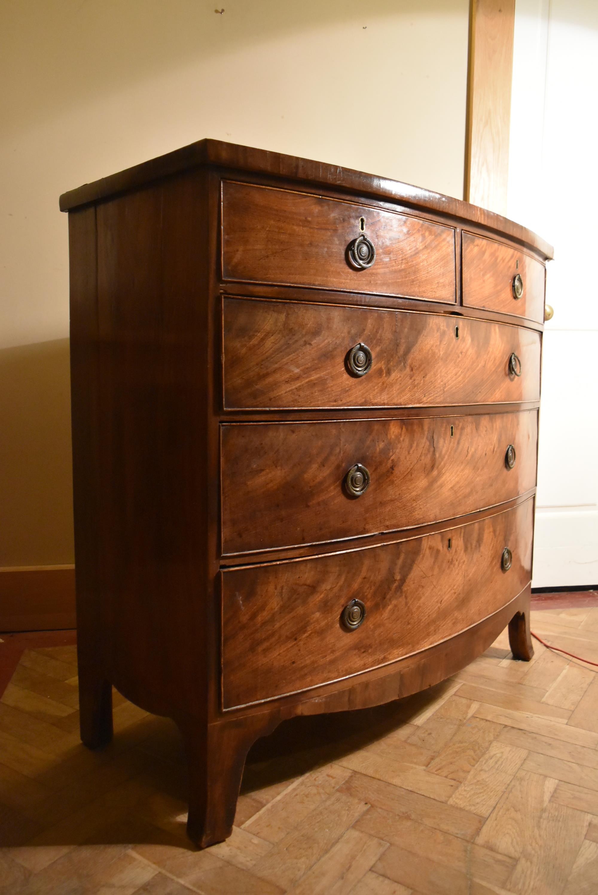 A Georgian flame mahogany bow fronted chest on swept bracket supports. - Image 2 of 7