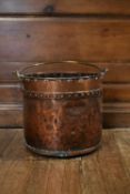 A 19th century copper fire log bucket with brass swing handle. H.30 Dia.35cm
