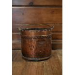 A 19th century copper fire log bucket with brass swing handle. H.30 Dia.35cm