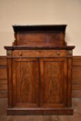 A Regency flame mahogany chiffonier with raised superstructure above frieze drawer and panel doors