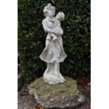 A composite white painted garden statue of a mother figure holding her child. H.96cm