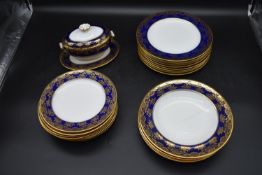 A Wedgwood gilded stylised foliate design part dinner service. Including 9 plates, 8 small plates, 4