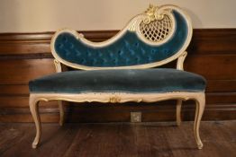 A white painted Rococo style small sofa in deep buttoned upholstery on cabriole supports. H.93 W.106