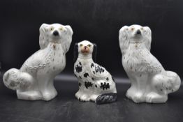 A pair of late 19th century ceramic Staffordshire dogs with one other small Staffordshire dog. H.