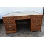 A mid century oak pedestal desk. (veneer missing as photographed)