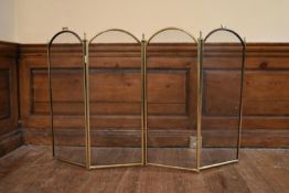 A brass framed four panel mesh fire screen. H.80 W.130cm